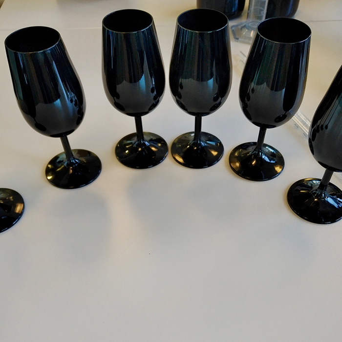 Black glasses, used for blind tasting during the blending process