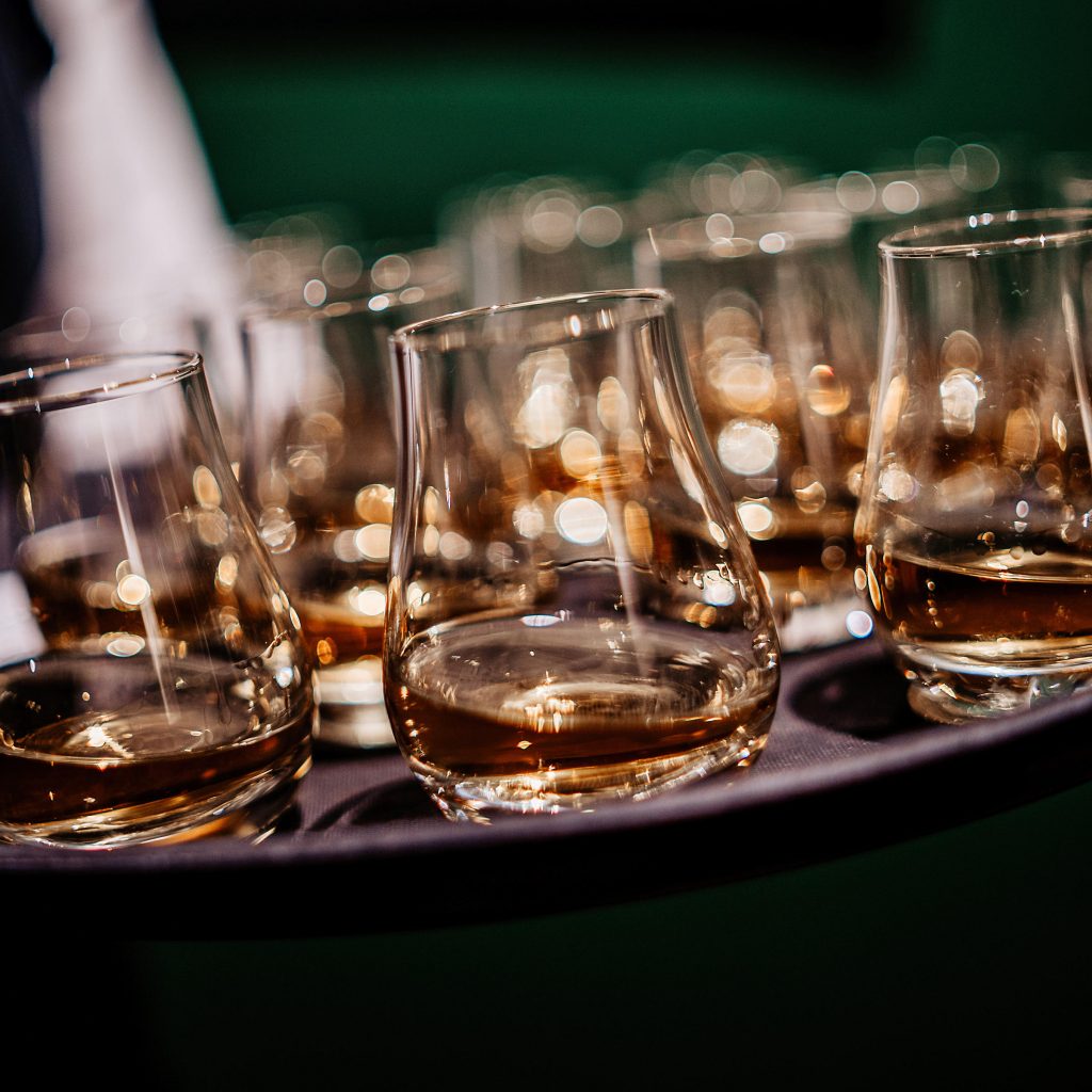 A photo depicting a tray of whisky glasses being served in our London Shop at 63 Pall Mall